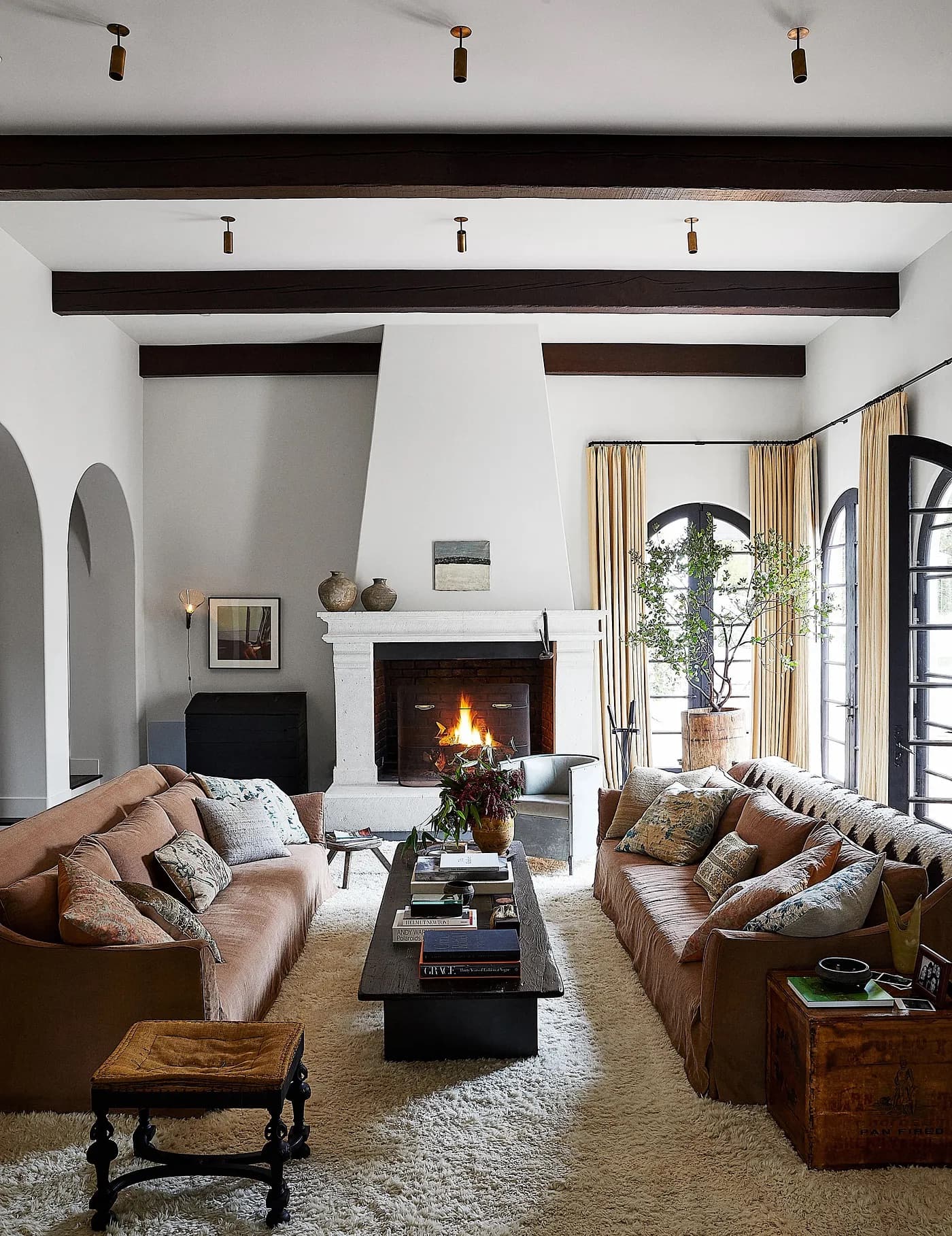 Kendall Jenner’s Los Angeles home, designed Kathleen and Tommy Clements. Notice how not every wall, ceiling, or floor surface is filled. Negative space can be seen between the sofas and coffee table, fireplace mantle and ceiling, between the wood ceiling beams, and between the architectural arches. This all allows for better flow and more emphasis on the important pieces.